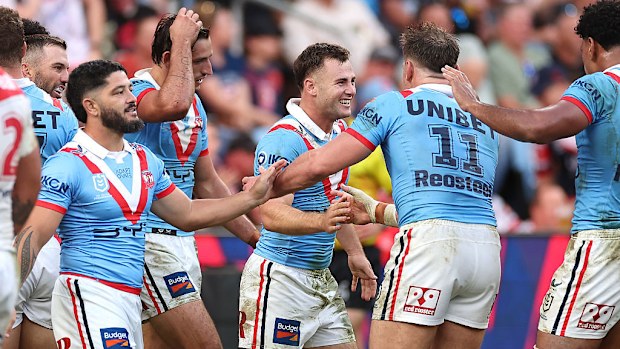 Sandon Smith of the Roosters celebrates with teammates after scoring a try.