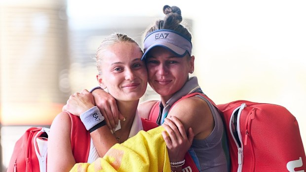 (L-R) Polina and Veronika Kudermetova share a hug.