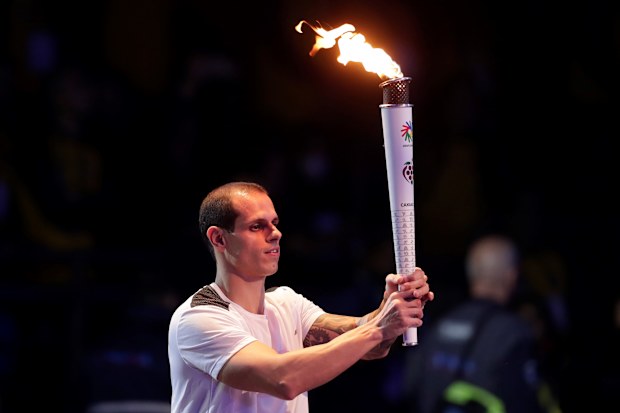 Swimmer Guilherme Maia passes the torch during the opening ceremony of the 2022 Deaflympics held in Brazil.