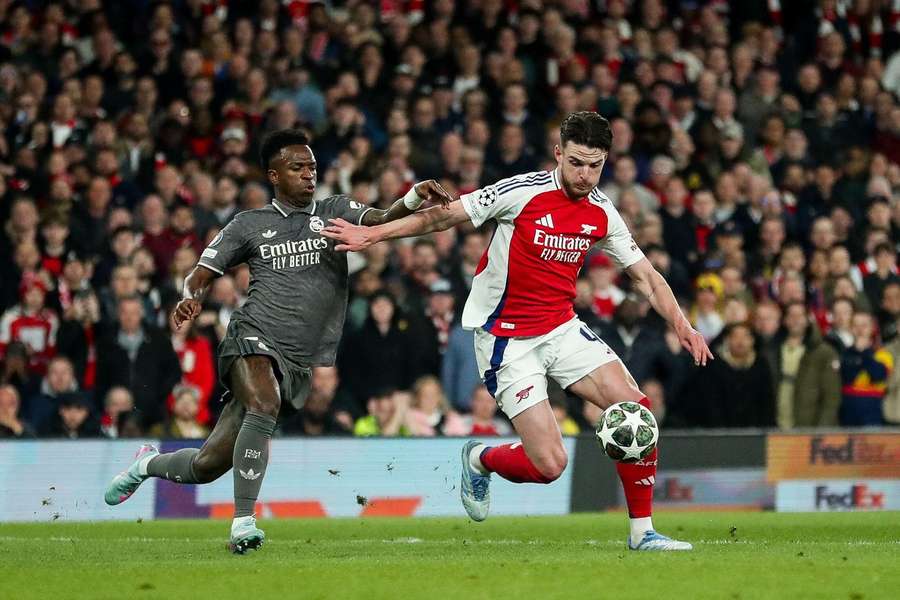 Arsenal's Declan Rice faces pressure from Real Madrid's Vinicius Jr during the Champions League quarter-final first leg