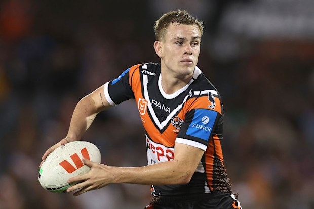 Lachlan Galvin of the Wests Tigers runs the ball.