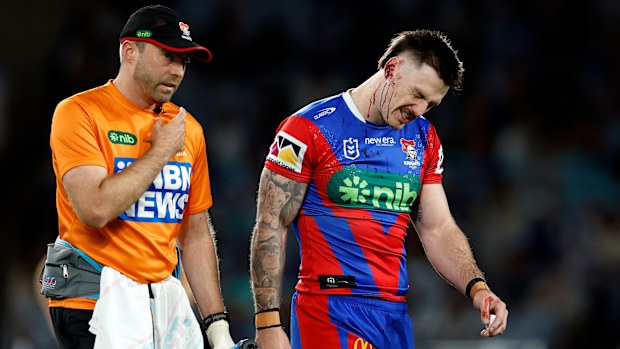 James Schiller of the Knights departs the field injured.