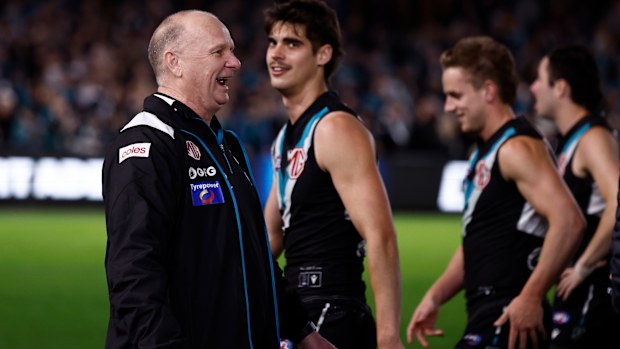 Ken Hinkley, Senior Coach of the Power exchanges words with Hawthorn players 