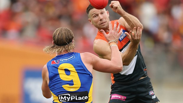 Toby Greene handballs over Harley Reid in round four.