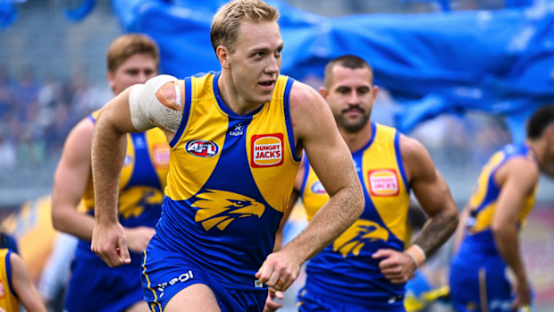 West Coast's Oscar Allen leads his team out onto the field.