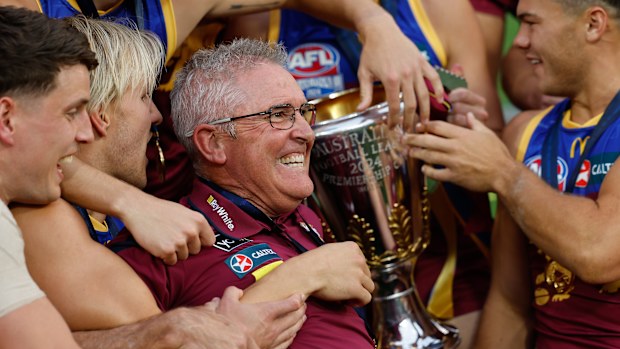 Chris Fagan, Senior Coach of the Lions celebrates with his team during the 2024 AFL Grand Final.
