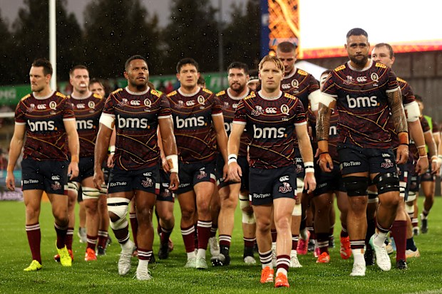 Tate McDermott of the Queensland Reds leads the team off the field.
