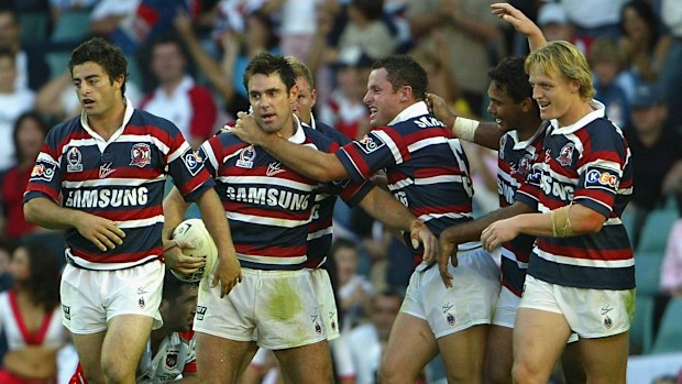 Roosters players celebrating with Brad Fittler after he scored a try during the NRL round seven match between the Sydney Roosters and the St George/Illawarra Dragons at Aussie Stadium, April 25, 2004 in Sydney, Australia. (Photo by Chris McGrath/Getty Images)