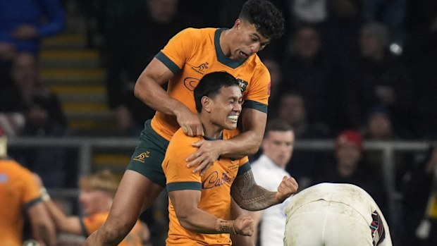 Australia's Len Ikitau and Joseph-Aukuso Suaalii celebrating after Max Jorgensen scores.