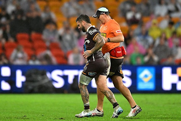 Adam Reynolds of the Broncos is helped off the field.