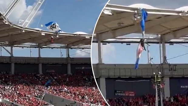 A parachutist required rescuing ahead of a Champions Cup match after getting stuck on the roof of Toulouse Stadium.
