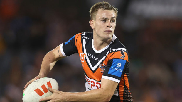 Lachlan Galvin of the Wests Tigers runs the ball.
