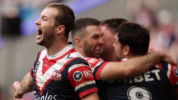 Sam Walker celebrates a try with teammates including Victor Radley.