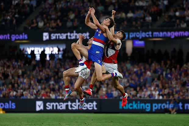 Sam Darcy of the Bulldogs and Anthony Caminiti of the Saints compete for the ball.