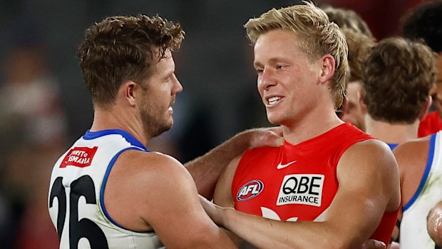 Luke Parker of the Kangaroos and Isaac Heeney of the Swans embrace during the 2025 AFL Round 04 match between the North Melbourne Kangaroos and the Sydney