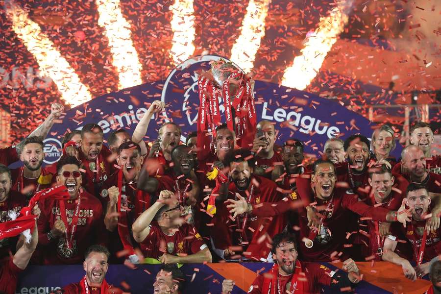 Liverpool celebrate lifting the Premier League trophy at an empty Anfield following their victory over Chelsea in 2020.