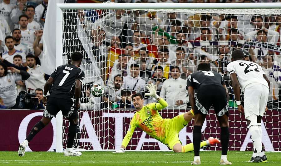 Real Madrid goalkeeper Thibaut Courtois saves a penalty from Arsenal's Bukayo Saka during the Champions League quarter-final second-leg on 16 April, 2025