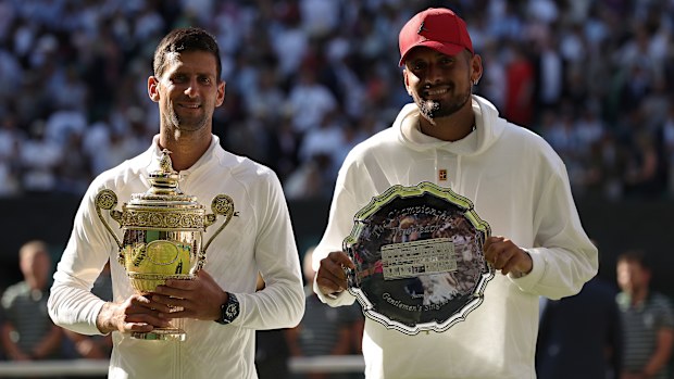 Novak Djokovic and Nick Kyrgios pose with their trophies after the 2022 Wimbledon final.