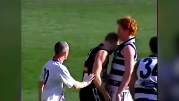 Nathan Buckley wipes blood from his head onto Cameron Ling.