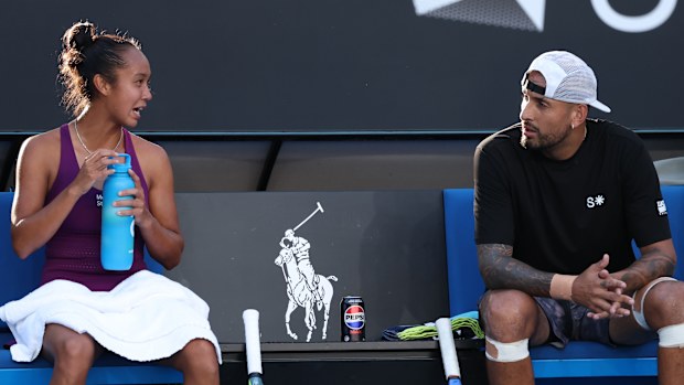 Nick Kyrgios of Australia talks with Leylah Fernandez of Canada competing at the AO mixed doubles.