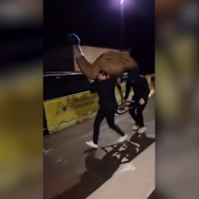 Two members of Slovakia's team steal Bruce the Emu.