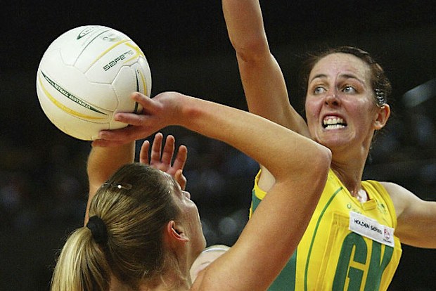 Irene Van Dyk of New Zealand shoots for goal as Australia's Liz Ellis defends.