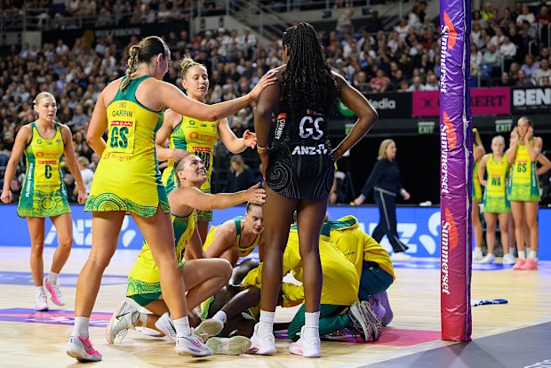 Australian players comfort Grace Nweke of New Zealand after Sunday Aryang got injured.