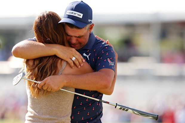 Gary Woodland embraces wife Gabby Granado on the 18th green after winning the Texas Children's Houston Open.