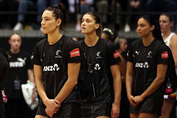 Karin Burger of New Zealand leading her team onto the court.