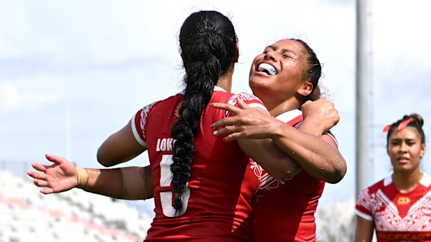 Tonga players celebrate a try.