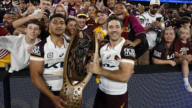 Josiah Karapani and Ben Hunt of the Broncos celebrating with the premiership trophy.