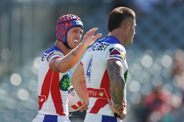 Kalyn Ponga celebrates scoring with teammate Bradman Best.