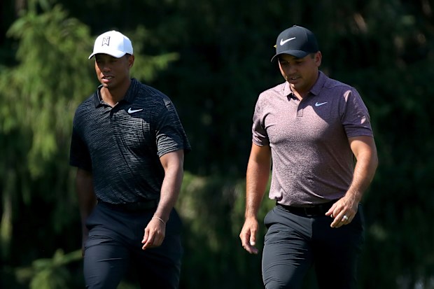 Tiger Woods and Jason Day walk the fairways.
