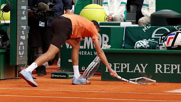 Daniil Medvedev smashes his racquet near his bench.