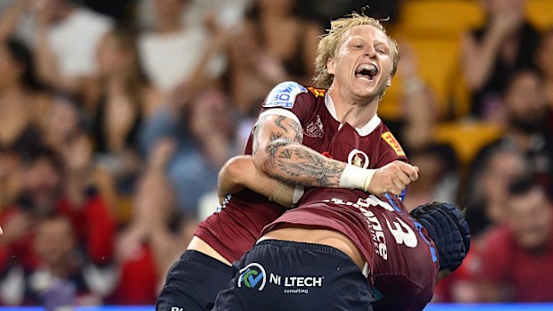 Carter Gordon of the Reds celebrates with team mates after scoring a try during the round nine Super Rugby match.