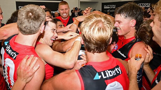 The Bombers celebrate winning the round five AFL match.