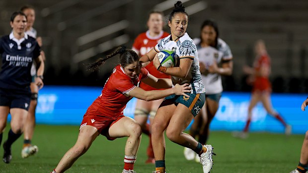Nicole Ledington of the Wallaroos tackles Taylor Perry of Canada.