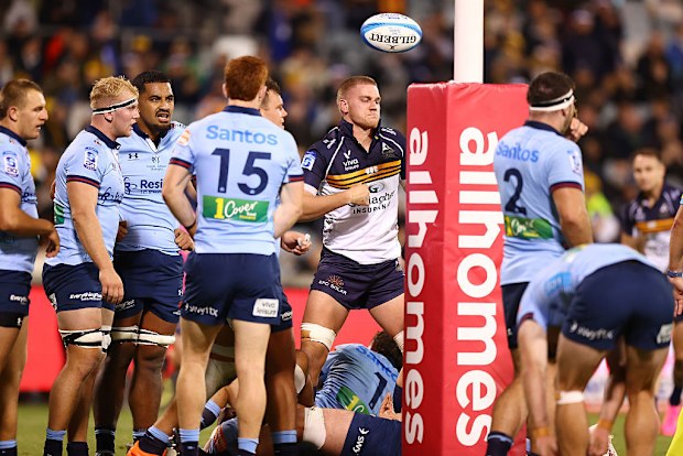Charlie Cale of the Brumbies celebrates scoring a try.
