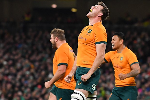 Nick Frost (middle) celebrates after the Wallabies score.