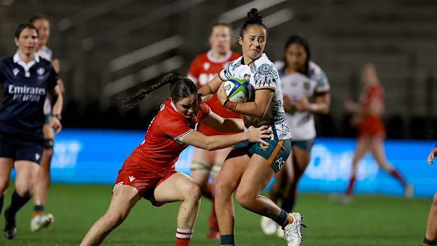 Nicole Ledington of the Wallaroos is tackled by Taylor Perry of Canada.