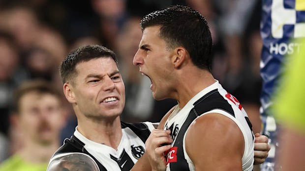 Nick Daicos and Jamie Elliott celebrate a goal.