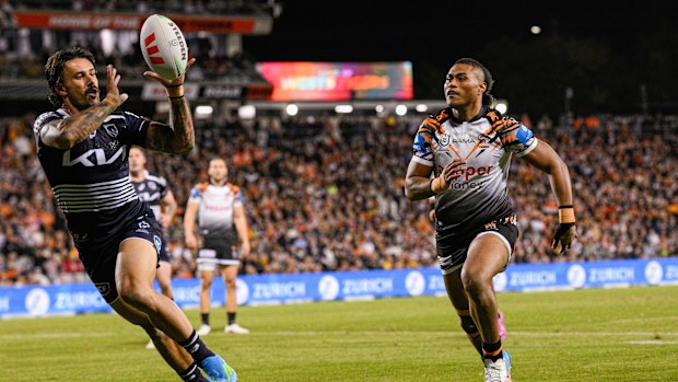 Jesse Arthars of the Broncos advances while picking up the ball.