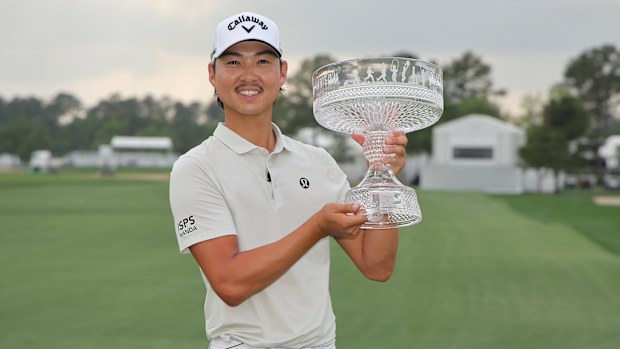 Min Woo Lee of Australia celebrates with the trophy after winning the Texas Children's Houston Open 2025 at Memorial Park Golf Course on March 30, 2025 in Houston, Texas. (Photo by Jonathan Bachman/Getty Images)