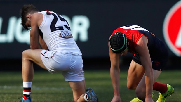 Koby Stevens of the Saints and Angus Brayshaw of the Demons recover after a collision during the 2017 AFL season.