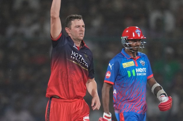 Josh Hazlewood celebrates taking the wicket of Delhi Capitals' Abishek Porel.