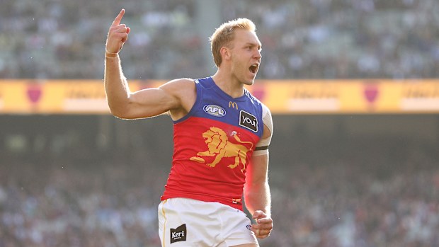 Oscar Allen of the Lions celebrates kicking a goal.