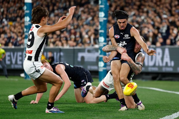MELBOURNE, AUSTRALIA - APRIL 16: Elijah Hollands of the Blues is tackled by Tim Membrey of the Magpies during the 2026 AFL Round 06 match between the Carlton Blues and the Collingwood Magpies at the Melbourne Cricket Ground on April 16, 2026 in Melbourne, Australia. (Photo by Michael Willson/AFL Photos via Getty Images)