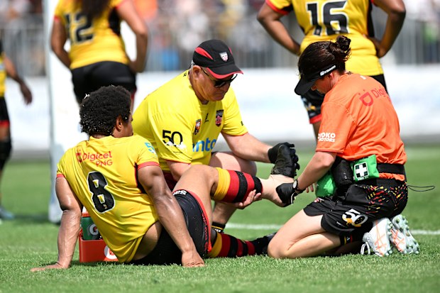 Elsie Albert receives medical attention from team trainers.