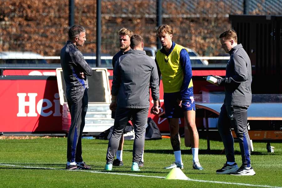 Luciano Valente from Feyenoord (2-R) clutches his leg as he departs Tuesday's training session