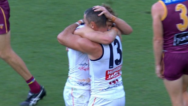 Tex Walker and Jordan Dawson embrace.